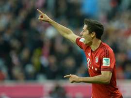 Bayern Munichs striker Robert Lewandowski celebrates after he scores during a German first division Bundesliga football match against Borussia Dortmund in Munich, southern Germany, on October 4, 2015