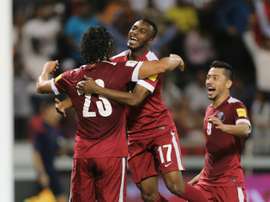 Qatars Sebastian Soria (L) is congratulated by teammate Ismaeel Mohammad (C) after he scored a goal during a 2018 World Cup football qualifying match against Hong Kong in Doha on March 24, 2016