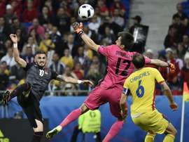 Albanias forward Armando Sadiku (L) scores the opening goal past Romanias goalkeeper Ciprian Anton Tatarusanu (C) and defender Vlad Chiriches on June 19, 2016