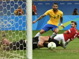 Gabriel (C) of Brazil kicks the ball to score against Denmark during the Rio 2016 Olympic Games Group A football match