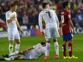 Real Madrids defender Dani Carvajal (down) reacts to an injury on October 4, 2015