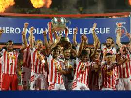 Atletico de Kolkata players celebrate with the trophy. AFP