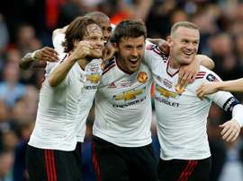 Manchester Uniteds Daley Blind (L), Ashley Young (2nd L), Michael Carrick (2nd R) and Wayne Rooney celebrate on the final whistle after extra time in the English FA Cup final football match at Wembley stadium in London on May 21, 2016