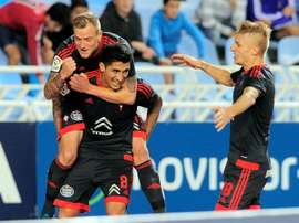 Celta Vigos midfielder Pablo Hernandez (C) celebrates a goal with teammates John Guidetti (L) and Daniel Wass (R) during the Spanish league football match Real Sociedad vs Celta Vigo in San Sebastian on October 31, 2015