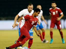 Qatars striker Akram Afif is marked by Russias defender Fedor Koudryashov (L) during the International friendly match between Qatar and Russia at the Jassim Bin Hamad Stadium in Doha on November 10, 2016
