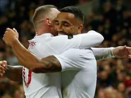 Wilson celebrates with Rooney after scoring against the USA. AFP