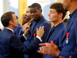Emmanuel Macron presented Paul Pogba with the Legion of Honour order of merit in 2019. AFP