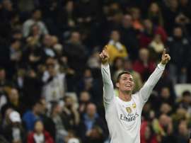 Real Madrids forward Cristiano Ronaldo celebrates after scoring during a UEFA Champions League Group A football match against Malmo at the Santiago Bernabeu stadium in Madrid on December 8, 2015