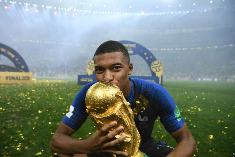 France forward Kylian Mbappe poses with the World Cup trophy. AFP