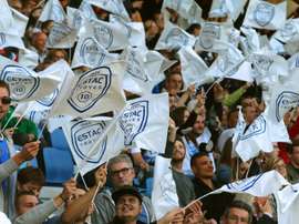 Troyes supporters wave flags prior to the French Football match between Troyes and Chateauroux, on May 22, 2015 at the Aube Stadium in Troyes, central France