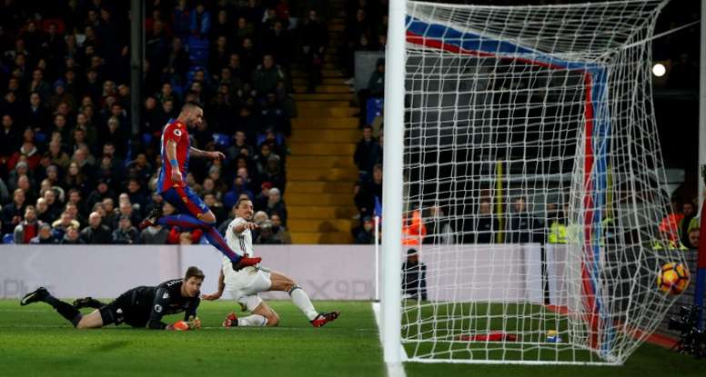 Manchester Uniteds striker Zlatan Ibrahimovic (R) slides the ball into the goal to score their second goal during the English Premier League football match between Crystal Palace and Manchester United on December 14, 2016