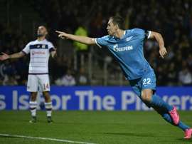Zenits Russian forward Artem Dzyuba (R) celebrates after scoring a goal as Lyons Spanish midfielder Sergi Darder (L) reacts during an UEFA Champions League Group H football match at the Stade de Gerland stadium in Lyon, France on November 4, 2015