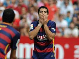 Barcelonas forward Luis Suarez (C) reacts during a Spanish league football match against Sevilla at the Ramon Sanchez Pizjuan stadium in Sevilla on October 3, 2015