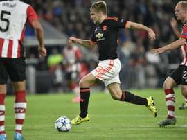 Manchesters Luke Shaw (C) vies with PSV Eindhovenâs midfielder Jorrit Hendrix (R) during the UEFA Champions League Group B football match at the Philips stadium in Eindhoven, Belgium on September 15, 2015