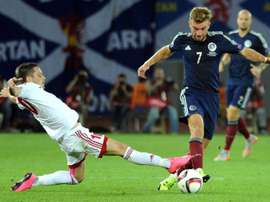 James Morrison (R) of Scotland vies for the ball with Jano Ananidze (L) of Georgia during their Euro 2016 qualifying football match in Tbilisi on September 4, 2015