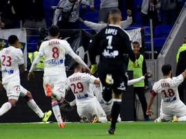 Lyons French forward Nabil Fekir (R) celebrates with teammates after scoring a goal