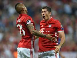 Bayern Munichs Robert Lewandowski (R) and Arturo Vidal celebrate after scoring a goal during their UEFA Champions League match against Rostov, in Munich, on September 13, 2016