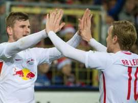 Leipzigs forward Timo Werner (L) celebrates with teammate forward Emil Forsberg after he scored during the German first division Bundesliga football match against SC Freiburg November 25, 2016