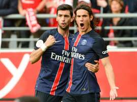 Paris Saint-Germains forward Edinson Cavani (R) is congratulated by his teammate on scoring during a French Ligue 1 football match against Reims on September 19, 2015 at the Auguste Delaune stadium in Reims