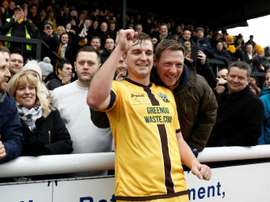 Sutton United's Jamie Collins celebrates with supporters. AFP