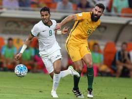 Australias Mile Jedinak (R) marks Saudi Arabias Nawaf Alabid during a 2018 FIFA World Cup qualifying match in Jeddah on October 6, 2016