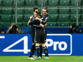 Real Madrid players celebrate after Gareth Bale (R) scored against Legia Warsaw. AFP