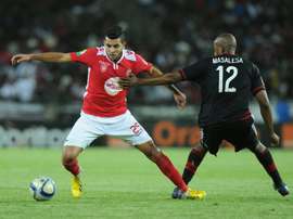 Orlando Pirates Lehlogonolo Masalesa (R) vies with Etoile du Sahels Mohamed Amine Ben Amor during the first final of the 2015 CAF - Confederation of African Football Cup match on November 21, 2015 at the Orlando Pirates Stadium in Johannesburg