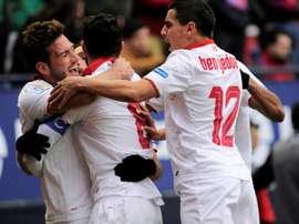 Sevilla players celebrate after their team scored the third goal against Osasuna. AFP