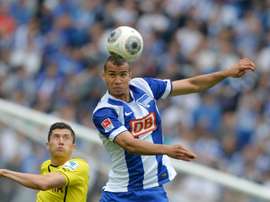 Dortmunds Polish striker Robert Lewandowski and Herthas defender John Anthony Brooks (right) vie for the ball during their Bundesliga match in Berlin on May 10, 2014