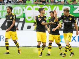 Dortmund players celebrate scoring the opening goal during the Bundesliga match against Wolfsburg