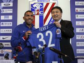 Carlos Tevez is all smiles during his presentation by Shanghai Shenhua. AFP