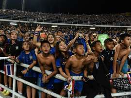 Local fans celebrate after Thailand won the AFF Suzuki Cup Final against Indonesia. AFP