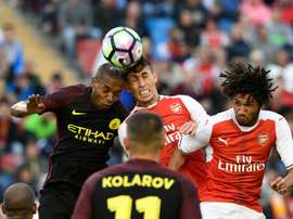 Arsenals defender Gabriel (C) jumps for the ball with Manchester Citys midfielder Fernando (L) during a friendly football match at the Ullevi stadium in Gothenburg on August 7, 2016