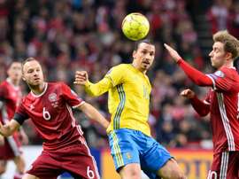 Swedens forward and team captain Zlatan Ibrahimovic vies with Denmarks defender Lars Jacobsen (L) during the Euro 2016 second leg play-off football match at Parken stadium in Copenhagen on November 17, 2015