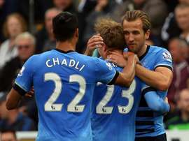 Tottenham Hotspurs Nacer Chadli (L) and Harry Kane (R) congratulate Christian Eriksen after he scored during an English Premier League football match against Swansea City at The Liberty Stadium in Swansea, south Wales on October 4, 2015