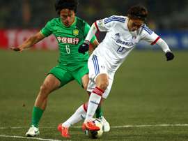 Zhang Xiaobin (left) of Beijing Guoan tussles for the ball against Seo Sung-jin of Suwon. AFP