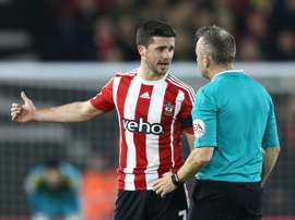 Southamptons striker Shane Long (L) talks with referee Jon Moss during an English Premier League football match against Arsenal on December 26, 2015
