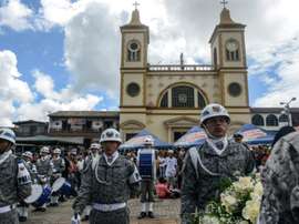 Soldiers take part in a ceremony to unveil a commemorative plaque. AFP