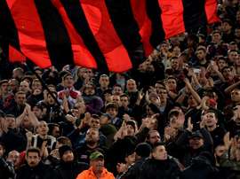 AC Milans fans cheer during the Italian Serie A football match between Lazio and AC Milan at Olympic Stadium in Rome on November 1, 2015