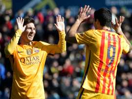 Messi et Suárez célèbrent un but. AFP