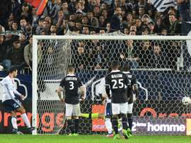 Lyons Emanuel Mammana (L) scores a late goal during their match against Bordeaux