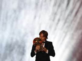 Real Madrid and Croatia midfielder Luka Modric kisses the trophy. AFP