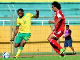 South African Bafana Bafana player Wamdisile Letlabika (L) fights Mauritius Club M player Perticots Kevin Joseph for possession during their 2016 African Nations Championship qualifier on July 5, 2015 in Mauritius