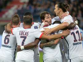 Paris Saint-Germains forward Angel Di Maria (2rd R) celebrates with teammates after scoring a goal during the French L1 football match between Caen and Paris Saint-Germain on December 19, 2015 in Caen, France