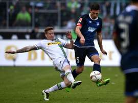 Moenchengladbachs midfielder Andre Hahn (L) and Hoffenheims Swiss defender Fabian Schaer vie for the ball during the German first division Bundesliga football match in western Germany, on April 24, 2016