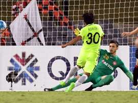 Shinzo Koroki of Urawa Red Diamonds scores past Western Sydney Wanderers goalkeeper Vedran. AFP