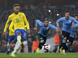 Brazil's Neymar scores the winner against Uruguay. AFP