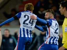 Herthas midfielder Genki Haraguchi (L) celebrates scoring with his team-mate defender Marvin Plattenhardt during the German Cup quarter final football match Heidenheim vs Hertha Berlin on February 10, 2016 in Heidenheim, Germany