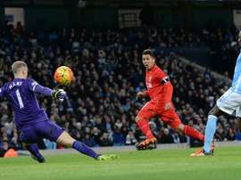 Liverpools midfielder Roberto Firmino (C) takes an unsuccessful shot on goal during the English Premier League football match between Manchester City and Liverpool at The Etihad stadium in Manchester, north west England on November 21, 2015
