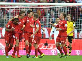 Bayern Munichs players celebrate scoring a goal during their German first division Bundesliga match against Borussia Dortmund, in Munich, on October 4, 2015